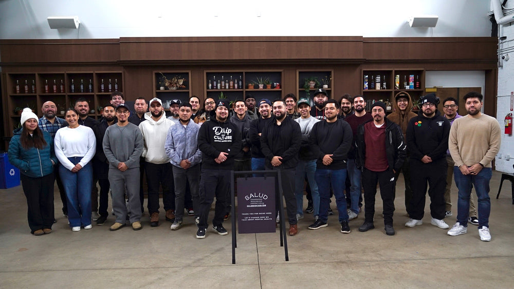 Group of people posing in front of a bar with 'Bally's' sign.